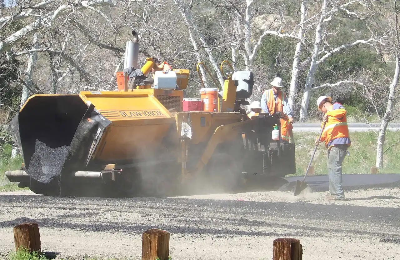 Interlocking concrete pavers being laid on a new driveway